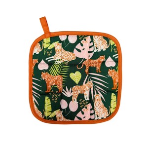 May include: Square pot holder with a jungle-themed pattern. The dark green fabric features orange tigers, pink and white leaves, and green foliage. The edges are trimmed with orange fabric and a matching loop for hanging.