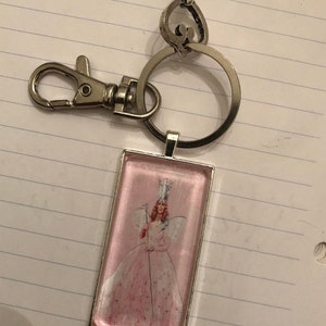 Glinda the Good Witch Wizard of OZ pink rectangle key chain, silver swivel clip and vintage key
