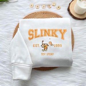 Slinky Est 1995 Toy Story Embroidered Sweatshirt, Disney Toy Story Shirt, Cute Dog Hoodie, Buzz Lightyear Shirt, Magic Kingdom Gift