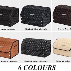 May include: Six different colored storage boxes with quilted fabric exteriors. The boxes are black with black, blue, red, brown, silver, and beige thread accents. The boxes are labeled with the color and thread color combination.