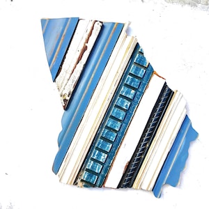 May include: A blue, white, and teal abstract wall art piece made from reclaimed wood. The wood is arranged in a diagonal pattern, creating a geometric design.