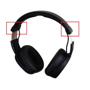 May include: Black over-ear headphones with a padded headband and earcups. The earcups are oval-shaped and the headband is adjustable. The headphones have a sleek, modern design, ideal for listening to music or podcasts.