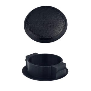 May include: Black plastic cap with a round top and a slightly raised edge. The cap has a textured surface and is designed to fit over a hole.