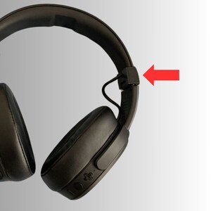 May include: Black over-ear headphones with a padded headband and earcups. The headphones have a matte finish and feature control buttons on the earcup. The design is modern and sleek, suitable for music listening or calls.