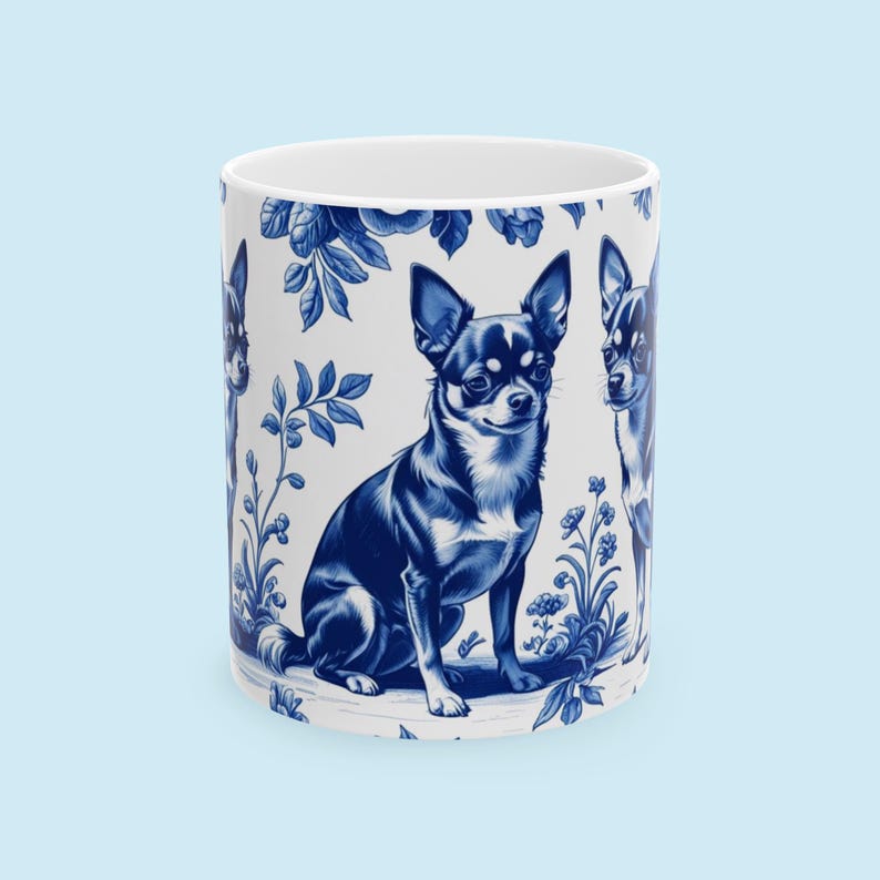 May include: White ceramic mug with a blue and white Chihuahua dog illustration. The design incorporates floral and botanical patterns, offering a classic, decorative look. The mug is cylindrical with a standard handle.