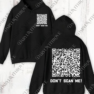 Op de afbeelding: Zwarte hoodie met een witte QR-code en de tekst "DON'T SCAN ME!" op de voor- en achterkant. De hoodie heeft een capuchon en lange mouwen.