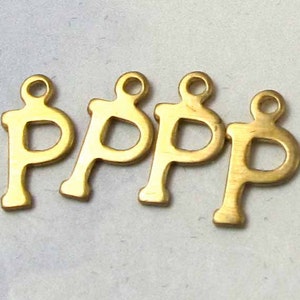 May include: Four gold-coloured metal letter charms in the shape of the letter 'P'.