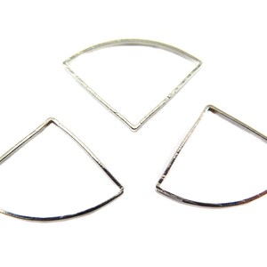 May include: Three silver-colored, open-backed, fan-shaped metal jewelry components. Each piece has a curved top and two straight sides, forming a geometric design. The components are displayed against a white background.