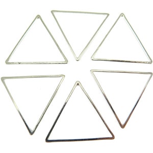May include: Six silver-colored triangle-shaped metal frames arranged in a circular pattern. Each frame has a thin, smooth border and a hollow center. The triangles are evenly spaced against a white background, creating a geometric design.