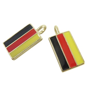 May include: Two gold-colored metal charms shaped like rectangles with the colors of the German flag: black, red, and yellow.