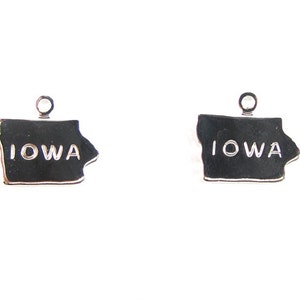 May include: Two silver charms shaped like the state of Iowa with the word "IOWA" inscribed on each charm.