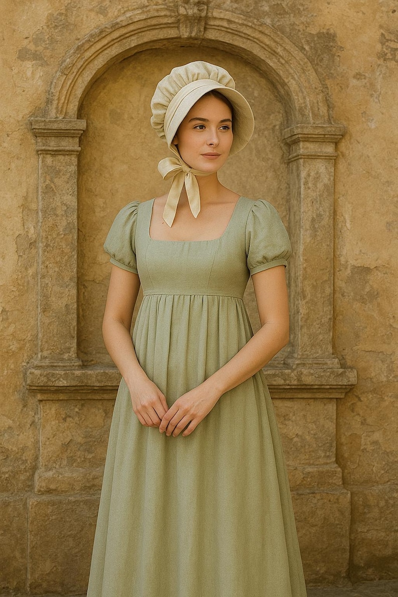 May include: A light green Regency-style dress with a square neckline and short, puffed sleeves. The dress features a gathered skirt and is paired with a matching bonnet with a ribbon tie. The background is a stone wall.