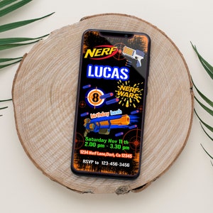 May include: A digital invitation for an 8th birthday party with a Nerf Wars theme. The invitation features a black background with a blue and orange Nerf gun, a target, and the text "NERF WARS" in a yellow and red font. The invitation also includes the text "Lucas" in a blue font and the date and time of the party.