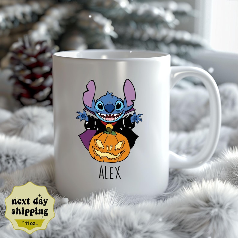 May include: White ceramic mug with a blue and purple cartoon character dressed as a vampire holding a jack-o-lantern. The mug has the name "ALEX" printed on the bottom.