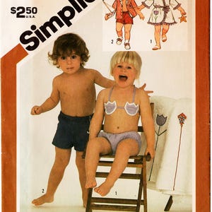 May include: A Simplicity 6010 sewing pattern envelope for toddler size 4 clothing. The cover features illustrations and photographs of a two-piece swimsuit with a shell-shaped top and matching bottoms, plus a robe and shorts set with appliques.