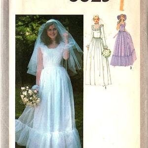 May include: Simplicity 8825 sewing pattern for a Misses' wedding dress. The image shows a woman wearing a white wedding dress with a veil and holding a bouquet. The pattern also includes illustrations of other dress designs. Size 10.