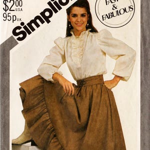 May include: Simplicity pattern 5648 featuring a woman wearing a blouse and skirt. The pattern includes sizes 10, 12, and 14. The text "Fast & Fabulous" is in a circle. The price is $2.00.
