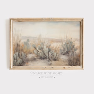 May include: A framed watercolor painting depicting a desert landscape with cacti and tall grasses in muted tones of green, brown, and beige. The painting is titled "Vintage West Works Art Gallery".