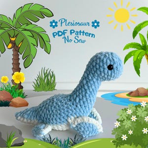 May include: A light blue crocheted plesiosaur toy with white accents. The toy is lying on a green grassy surface with a blue lake and a small island in the background. The text "Plesiosaur PDF Pattern No Sew" is written in blue on a white background.