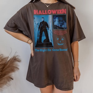Female model wearing a t-shirt featuring a vintage style Michael Myers graphic from the 1978 Halloween movie directed by the legendary john carpenter