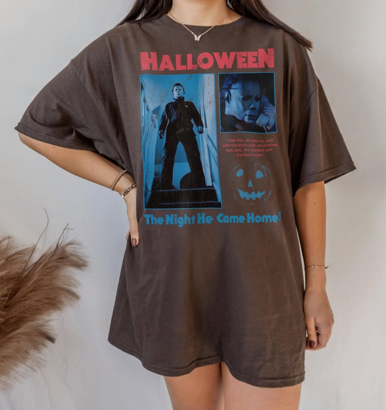 Female model wearing a t-shirt featuring a vintage style Michael Myers graphic from the 1978 Halloween movie directed by the legendary john carpenter