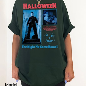 Female model wearing a forest green t-shirt with a vintage style Michael Myers design from John Carpenter's legendary horror film 1978 Halloween