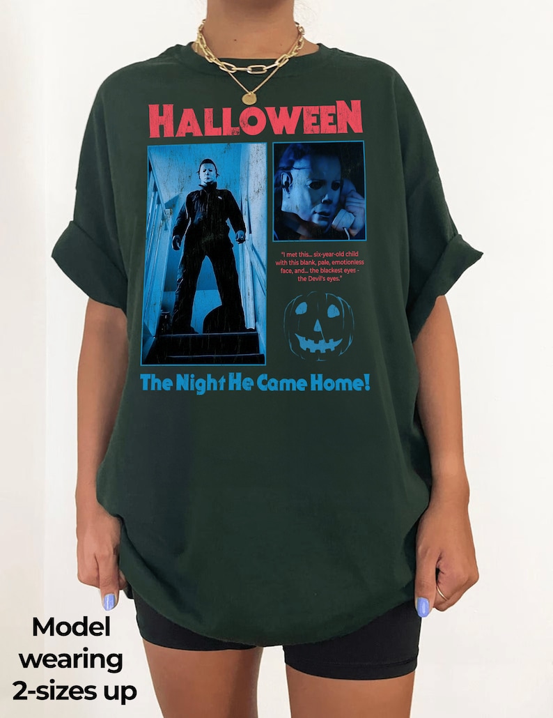 Female model wearing a forest green t-shirt with a vintage style Michael Myers design from John Carpenter's legendary horror film 1978 Halloween