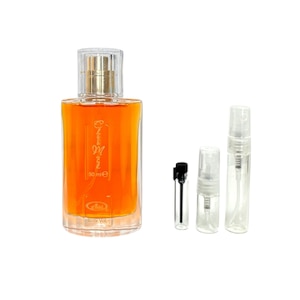 May include: A clear glass bottle of perfume with a gold cap and a label that says "Classic Gold" and "50 ml e". The bottle is next to three smaller clear glass bottles with spray tops.