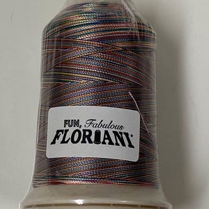 May include: A spool of multi-colored thread with a label that reads "FUN, Fabulous FLORIANI".