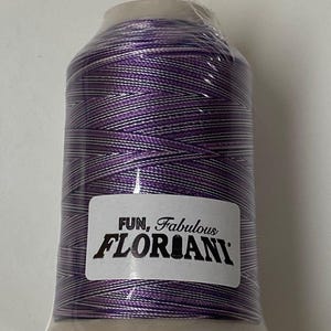 May include: A spool of purple and white embroidery thread with a label that reads "FUN, Fabulous FLORIANI."