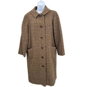 May include: A brown plaid coat with a classic design. The coat features a collared neckline, button-down closure, and two front pockets. The coat is displayed on a white mannequin. The coat's length extends to the mid-calf.