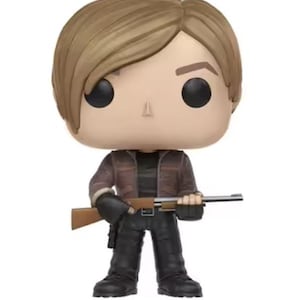 May include: A set of three ceramic mugs with a speckled, matte finish. The mugs are in shades of cream, light gray, and dark gray. Each mug has a simple, minimalist design and a rounded handle. The mugs are likely for coffee or tea.