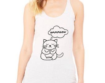 May include: A white tank top with a black and white illustration of a cat meditating with a thought bubble above its head that says "ommmeow".