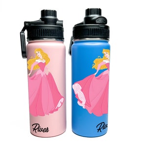 May include: Two insulated water bottles, one pink and one blue, each featuring a princess graphic in a pink gown. The bottles have black lids and the name "River" printed in black script on the bottom.