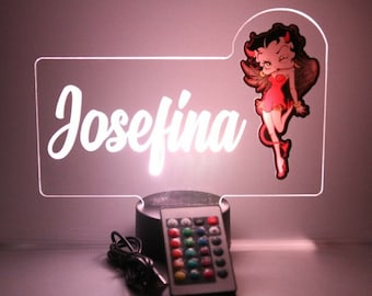 May include: A personalized LED night light with the name "Josefina" in white script. The design includes a cartoon image of a devilish woman in a red dress. A remote control is included for color adjustments.
