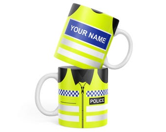 May include: Two white ceramic mugs with a design of a yellow safety vest. The top mug has the text "YOUR NAME" on the vest. The bottom mug has the text "POLICE" on the vest.