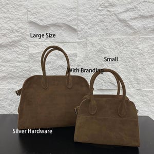 May include: Two brown suede handbags, one large and one small, with silver hardware. The bags have top handles and a rectangular shape. The image includes the text "Large Size", "Small", "With Branding", and "Silver Hardware".