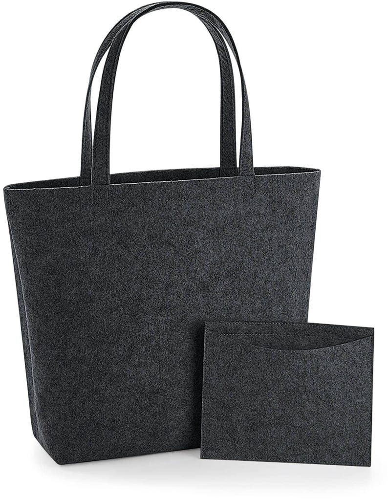 May include: A dark gray felt tote bag with matching handles and a smaller, rectangular felt pouch. The tote bag has a rectangular shape and a wide opening. The pouch is designed to fit inside the tote bag.