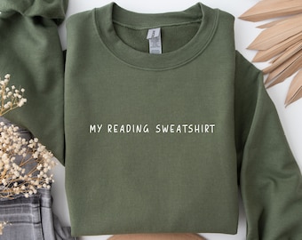 May include: A green sweatshirt with the text "MY READING SWEATSHIRT" in white.