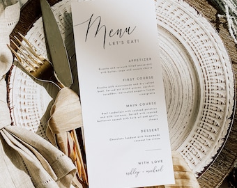 May include: A white rectangular menu card with black text reading Menu, Let's Eat!, Appetizer, First Course, Main Course, Dessert, and With Love Ashley + Michael, placed on a white textured plate with a gold fork, a silver knife, and a beige napkin.