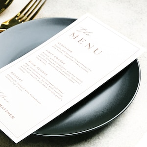 Minimalist printable wedding menu in a modern marigold color palette, displayed on a wedding reception table with simple decor. Editable dinner menu template designed for elegant events, perfect for brides wanting cohesive wedding stationery and an easy digital download to customize.