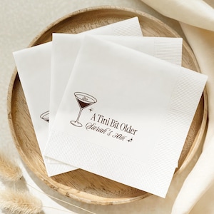 Neutral tone personalized party napkin with espresso martini illustration for 30th birthday celebration. A Tini Bit Older design printed with custom name and milestone age. Great for cocktail bars, house parties, and memorable milestone décor.