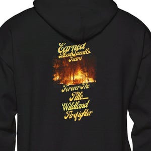 May include: Black hooded sweatshirt with a gold graphic that reads "Earned Blood Sweat & Tears Forever The Title Wildland Firefighter". The graphic features a burning forest.