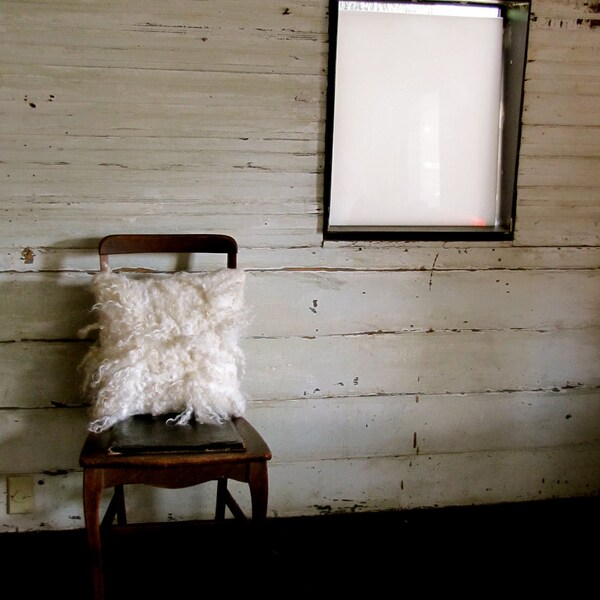 Handmade shaggy curly wool felt pillow in natural white