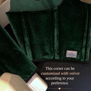 May include: A dark green velvet corset featuring vertical boning channels and a rectangular Vivienne Westwood MAN brand label. The garment includes text stating: This corset can be customized with velvet according to your preference.