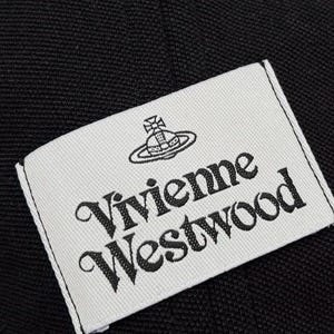 May include: A rectangular white fabric label stitched onto a black textured fabric background. The label features the black embroidered text Vivienne Westwood in a stylized serif font, positioned below a black embroidered orb and cross logo.