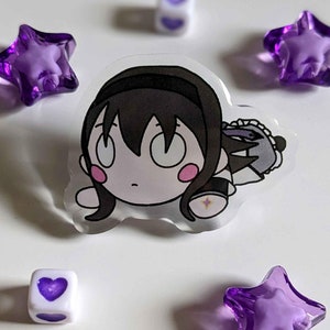 Könnte beinhalten: Ein transparenter Acryl-Anhänger mit einer Cartoon-Anime-Figur mit schwarzen Haaren, einem weißen Kleid und einem lila Stern. Der Anhänger ist von lila Sternen und herzförmigen Perlen umgeben.