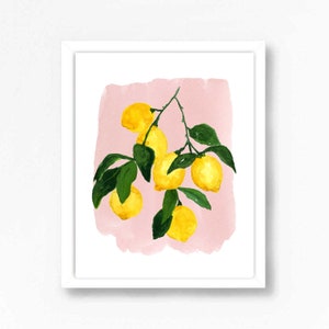 May include: Watercolor painting of a lemon branch with bright yellow lemons and green leaves against a pink background. The artwork is framed in a white border, creating a fresh and vibrant aesthetic.