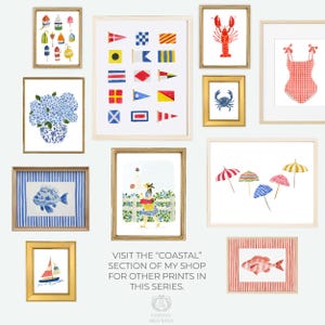 May include: A collection of framed watercolor prints with a coastal theme. The prints depict nautical flags, a lobster, a crab, a swimsuit, beach umbrellas, fish, a sailboat, and a lighthouse scene. The text reads "VISIT THE 'COASTAL' SECTION OF MY SHOP FOR OTHER PRINTS IN THIS SERIES."