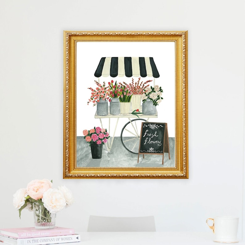 May include: A watercolor painting of a flower cart with a black and white striped awning. The cart is filled with pink, red, and white flowers. A chalkboard sign reads "Fresh Flowers".